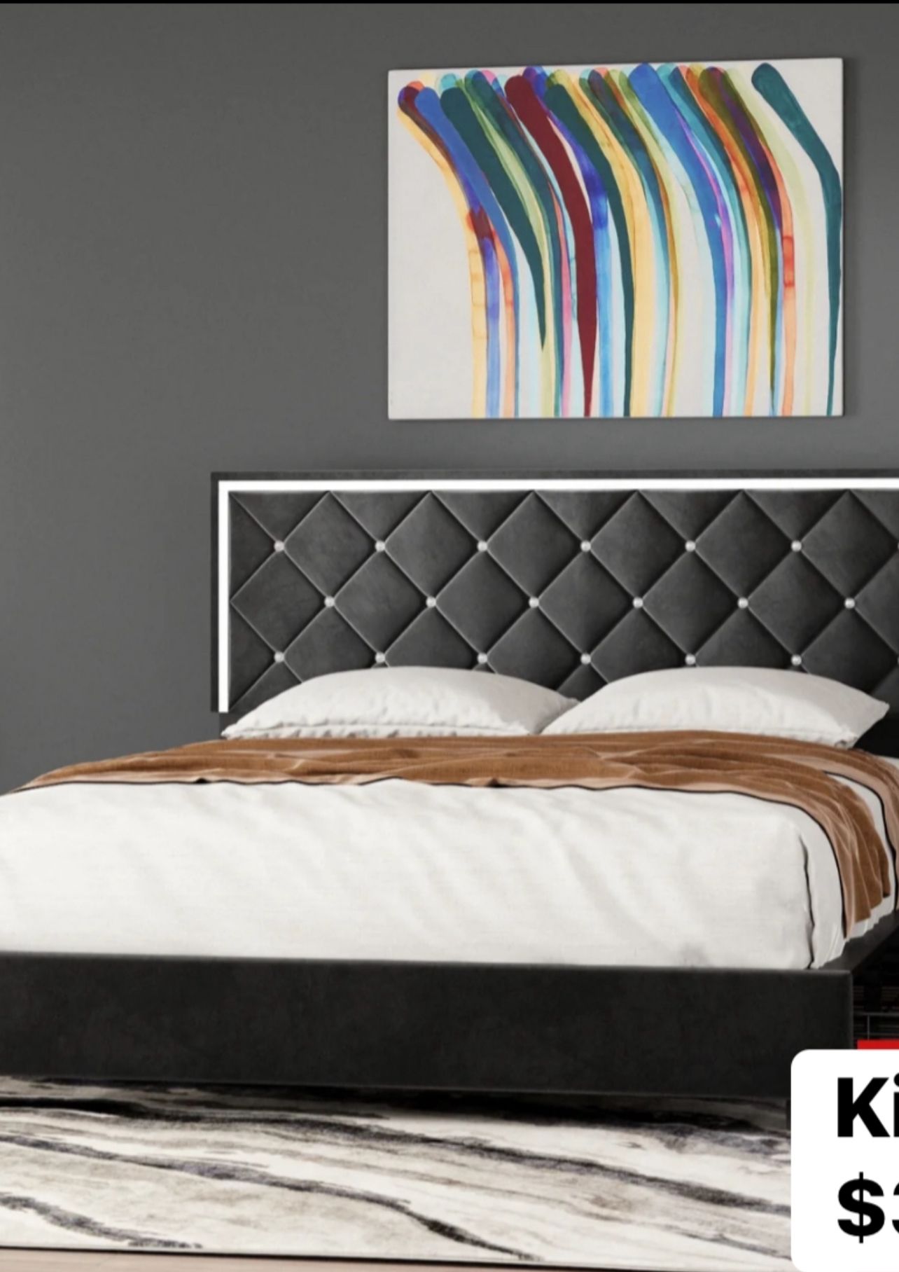 Modern bedroom with bed, armchair, window, and neutral color palette.