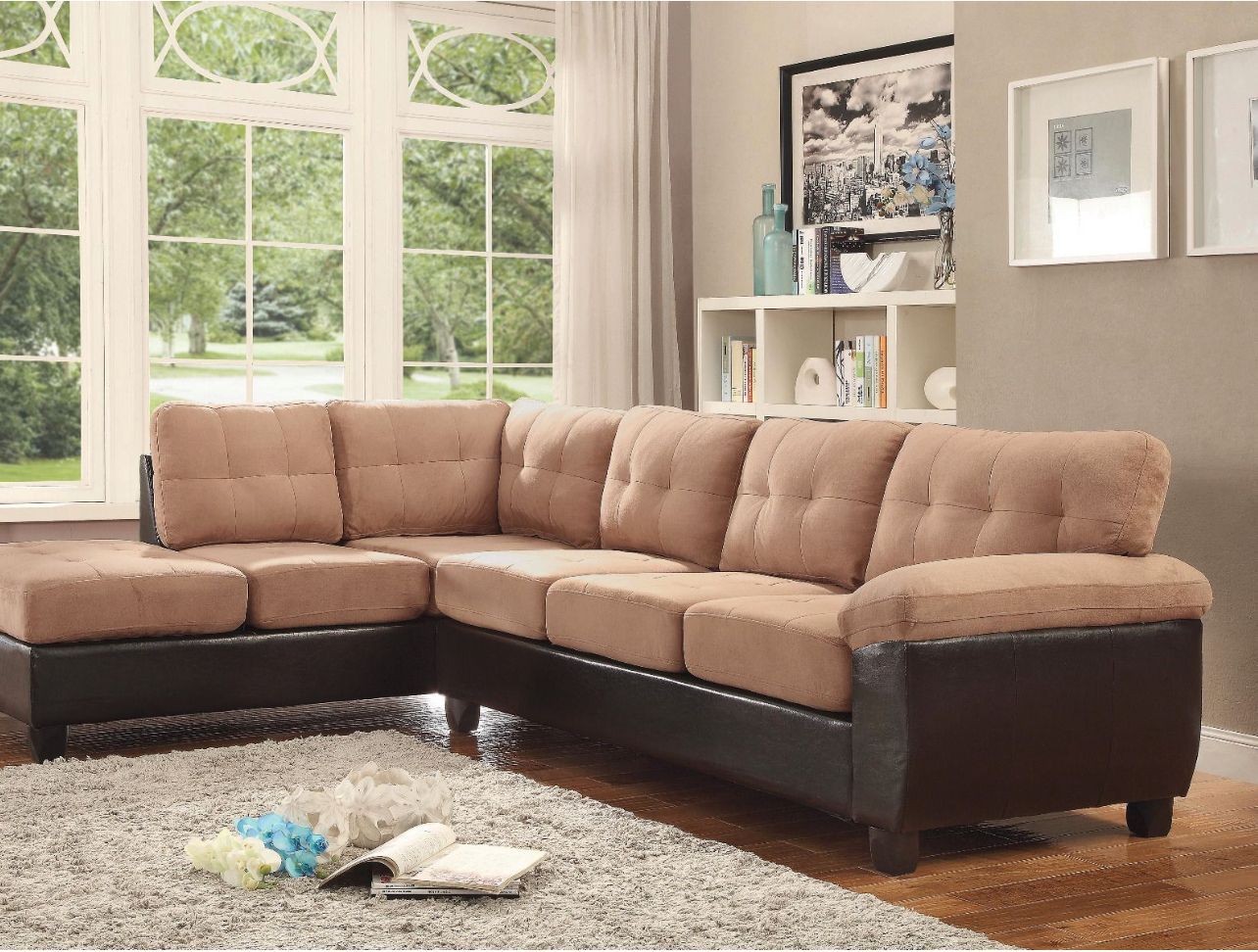 Spacious living room with gray sofa, white armchairs, marble coffee table, and built-in shelves.