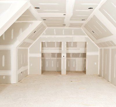 A new bonus room, with complex angles, at a residential construction site with tape and mud on the drywall seams.A related image from my portfolio