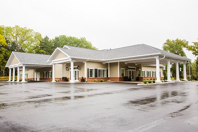a large building with a large parking lot in front of it .