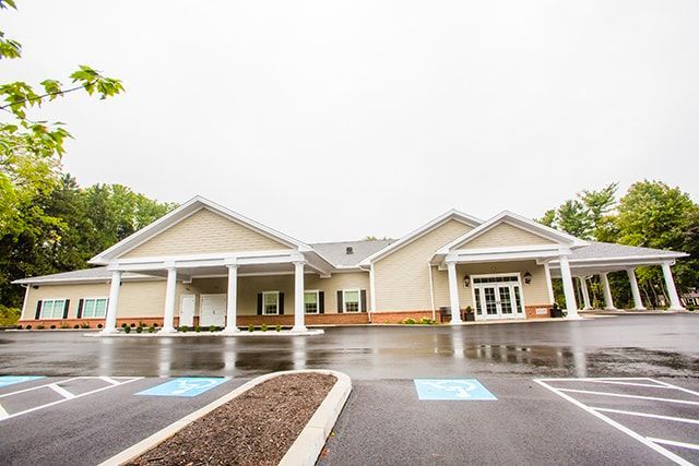 a large building with a handicapped parking spot in front of it .