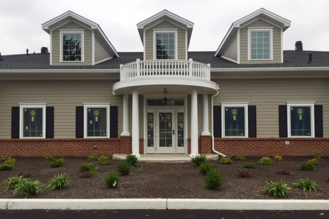a large house with a balcony and lots of windows