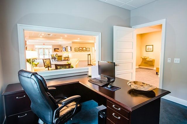 a home office with a desk , chair and computer .