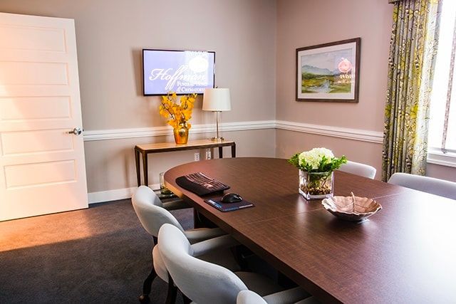 a conference room with a large round table and chairs