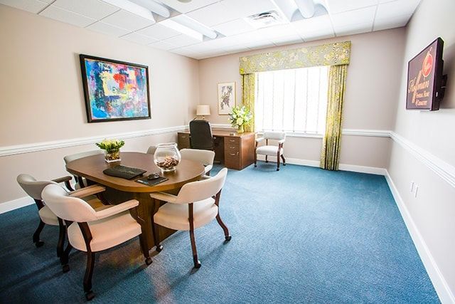 a conference room with a table and chairs and a desk .