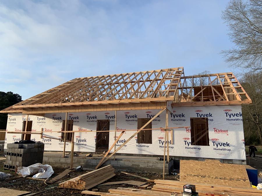 A house is being built with a roof that is being built.