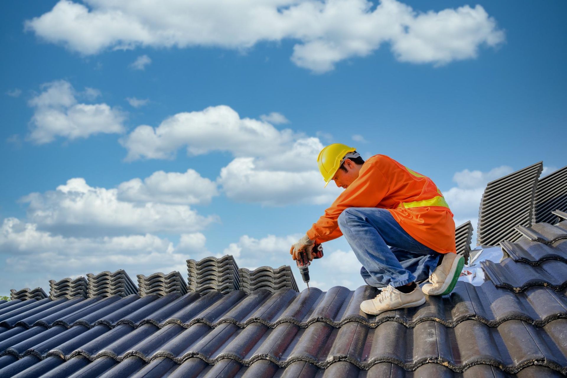 A man is working on the roof of a building.