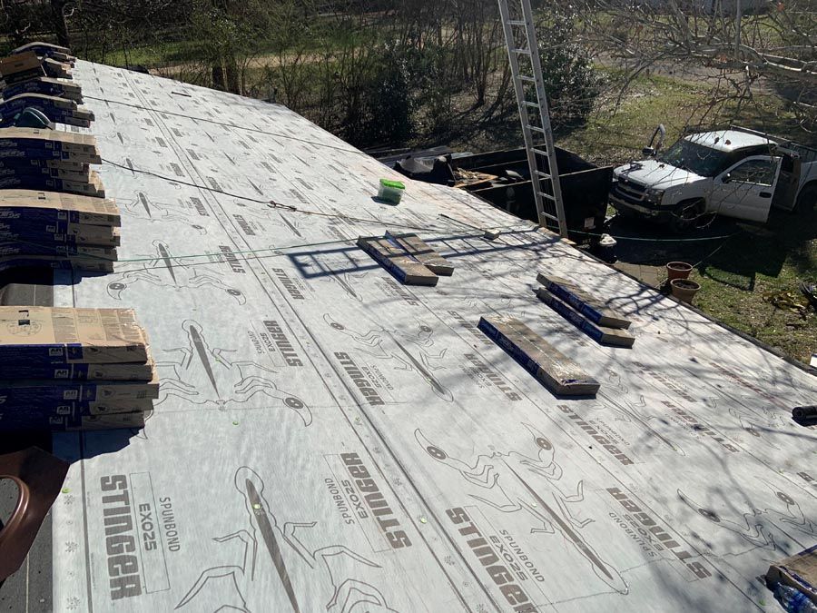 A truck is parked on the roof of a house under construction.