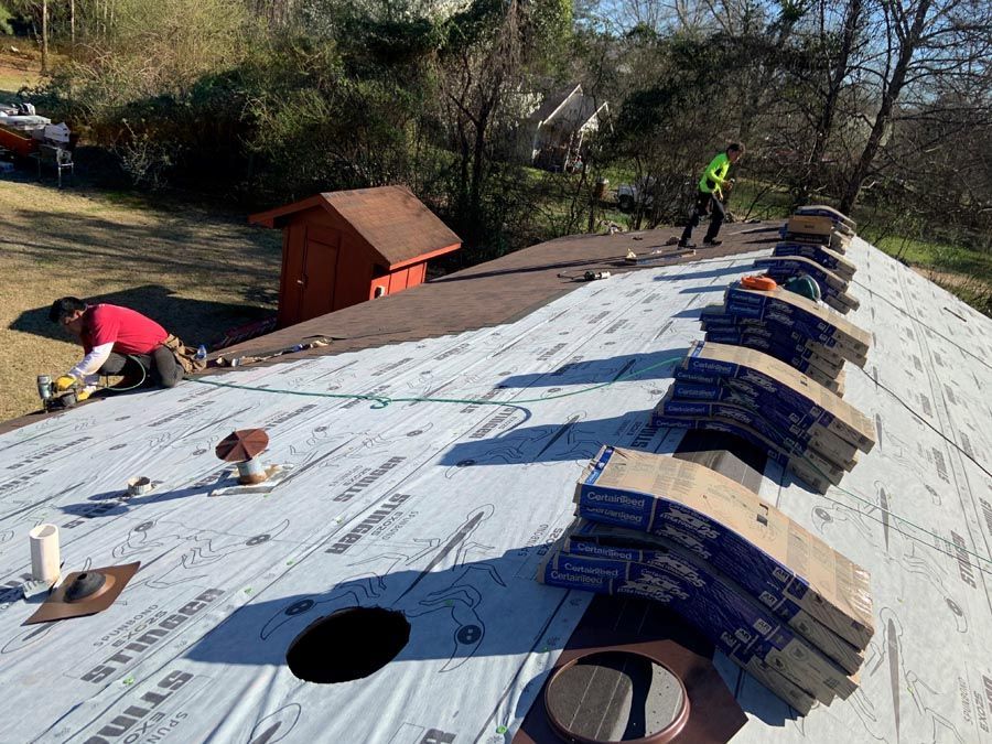 A man is working on the roof of a house.