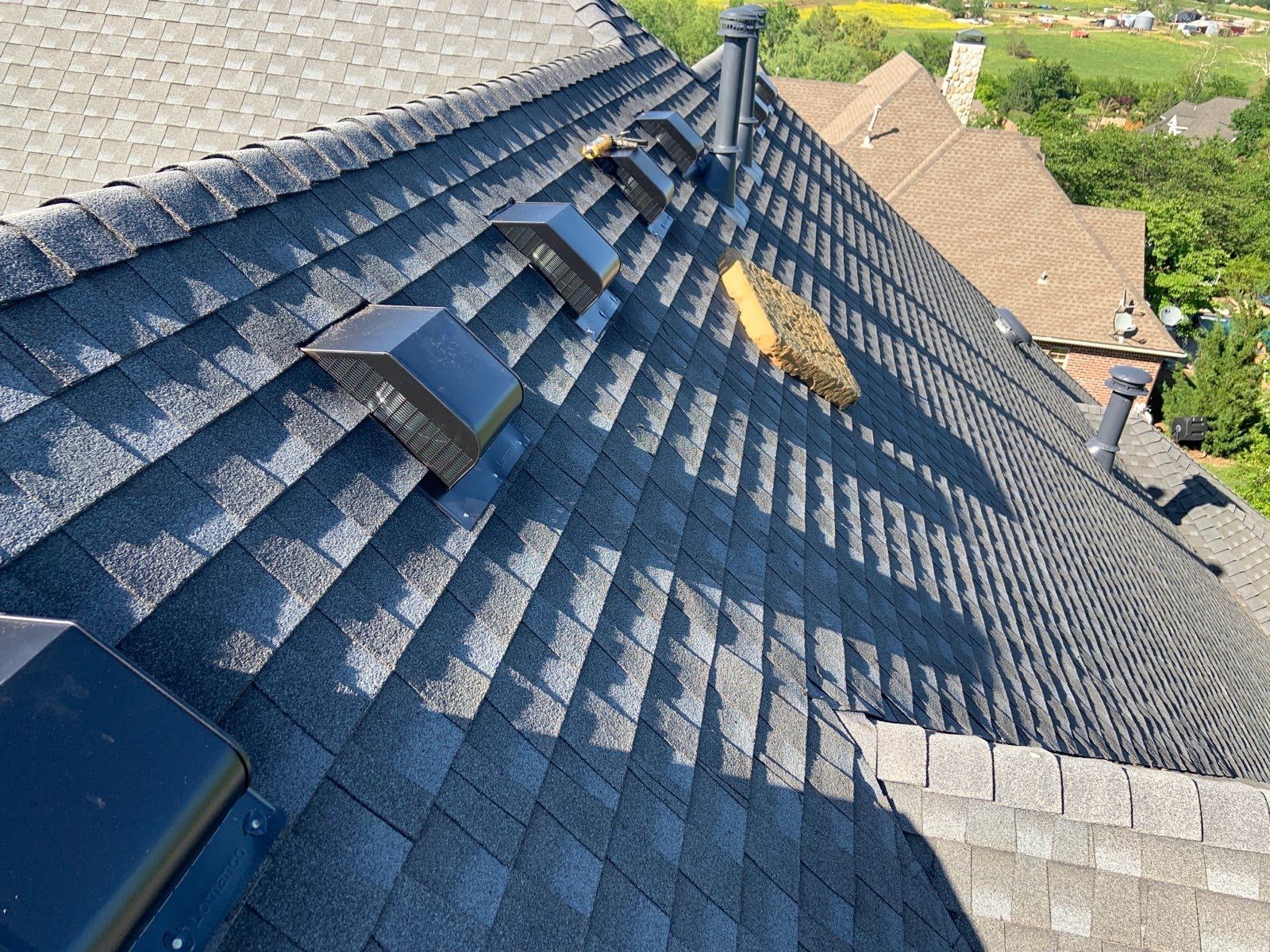 The roof of a house has a lot of shingles on it.