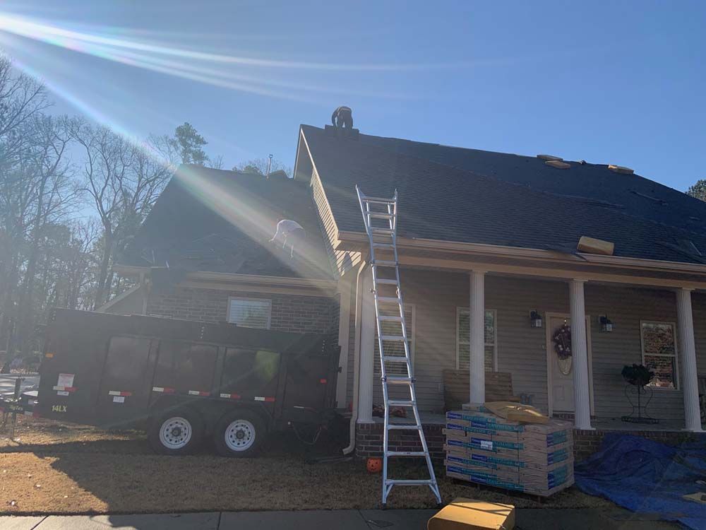 A ladder is sitting in front of a house under construction.
