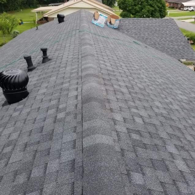 The roof of a house with a gray shingle roof.
