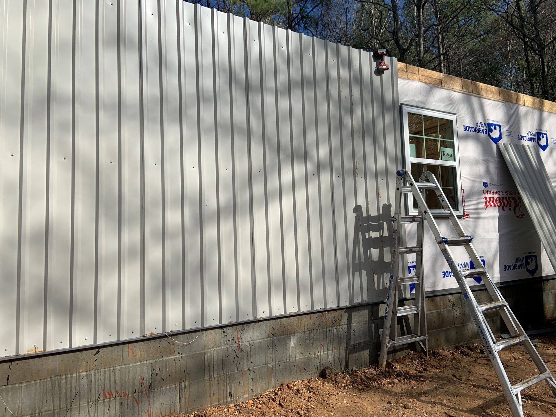 A ladder is leaning against the side of a building.