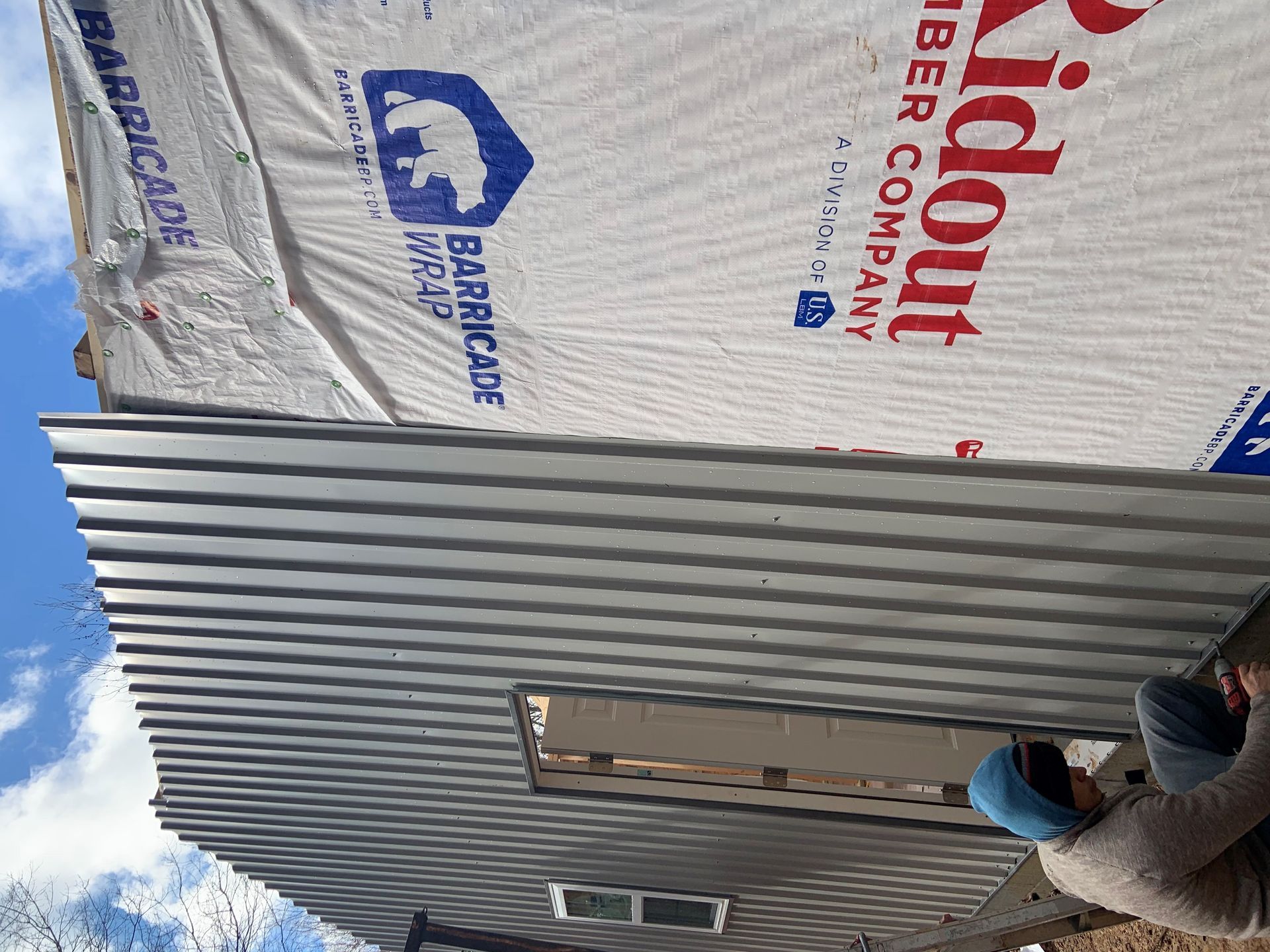 A person is standing in front of a building that is being built.