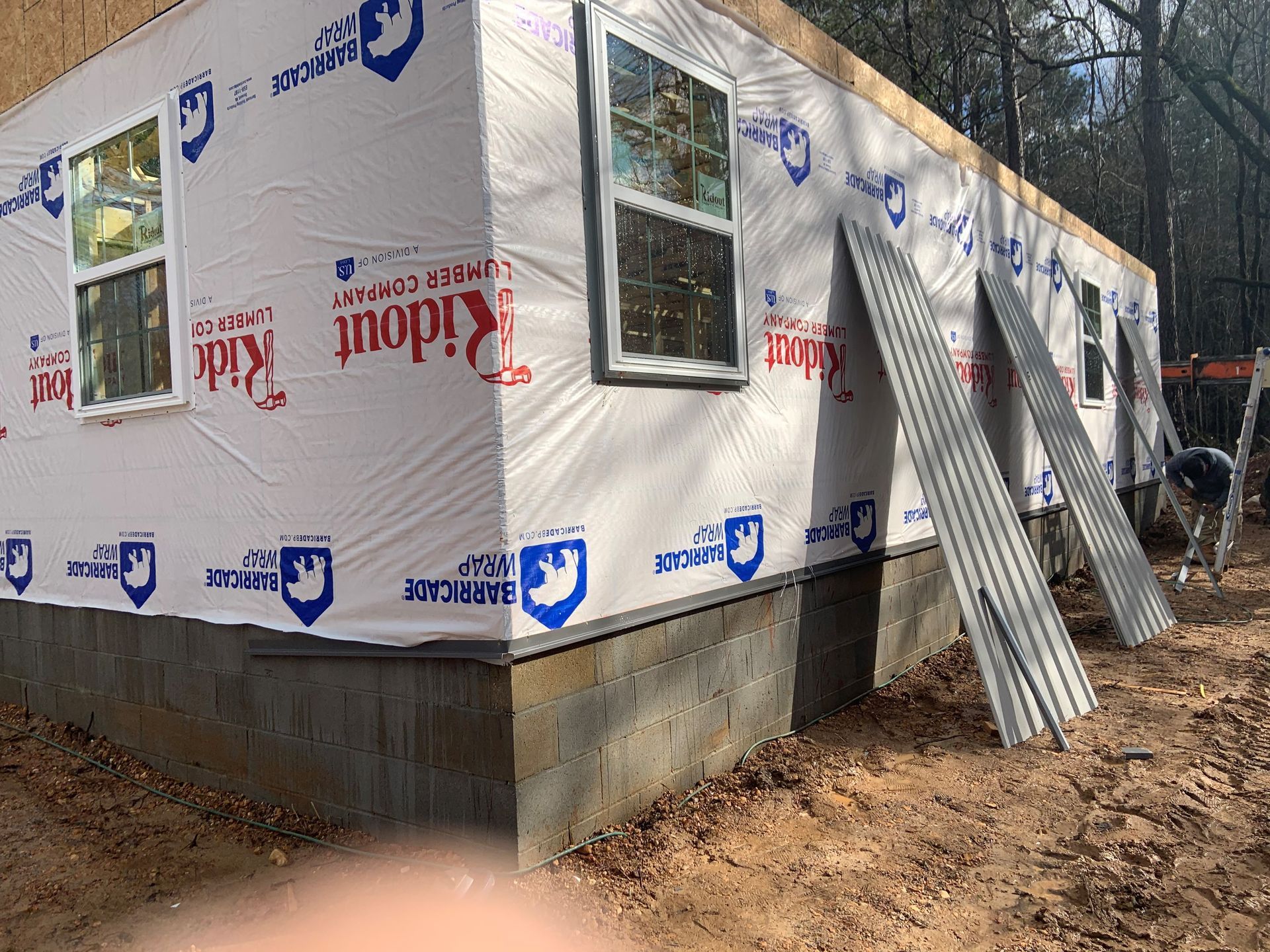 A house is being built with a lot of siding on it.