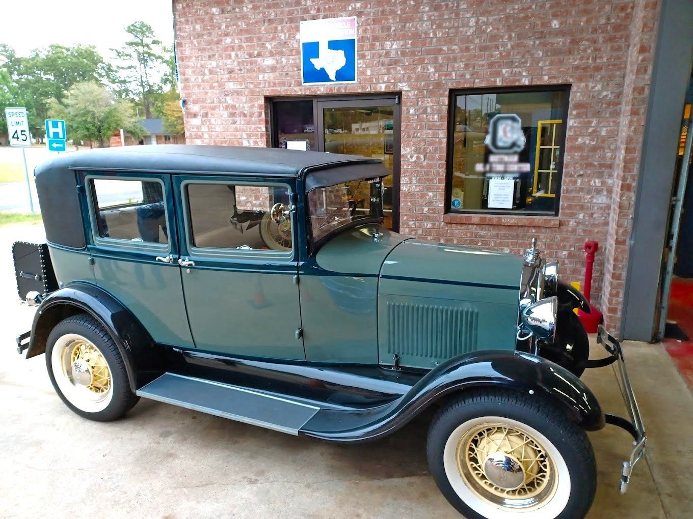 A red tow truck is parked in front of a building.
