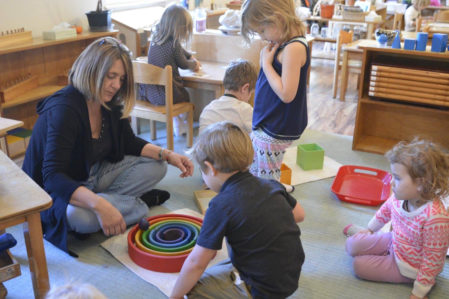 Teacher and children in a Montessori classroom