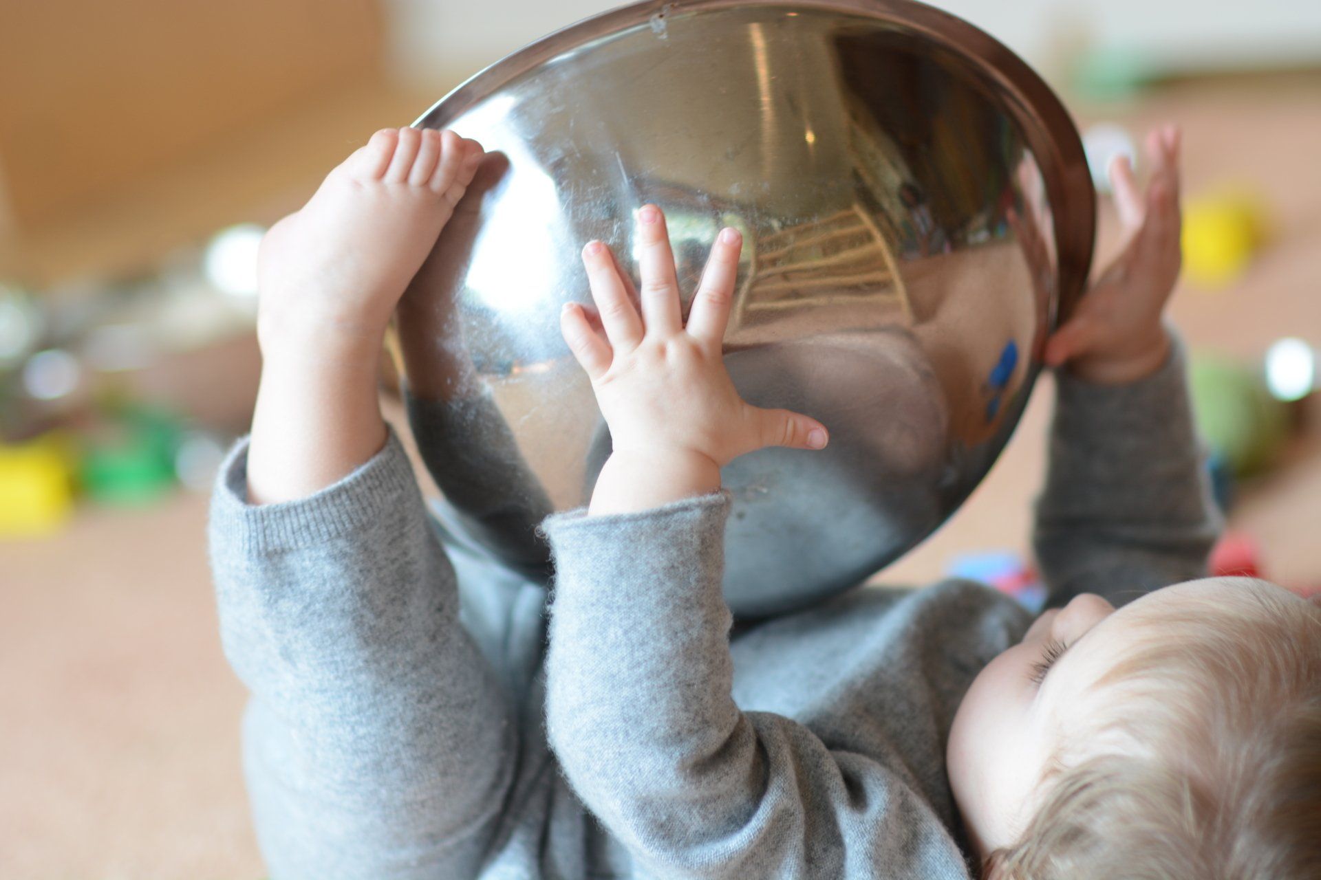 Infant holding a bowl