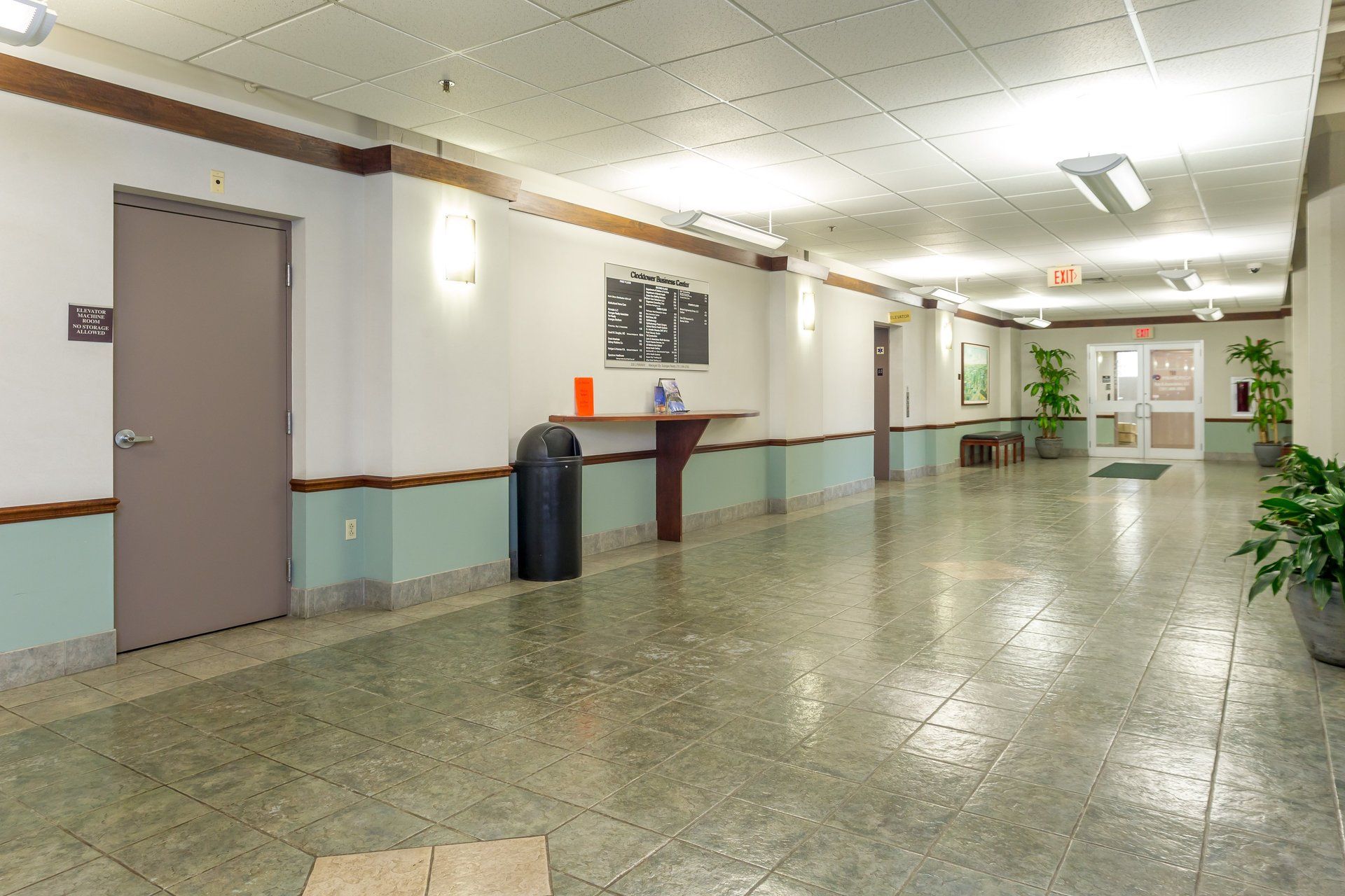 A long hallway with a trash can in the middle
