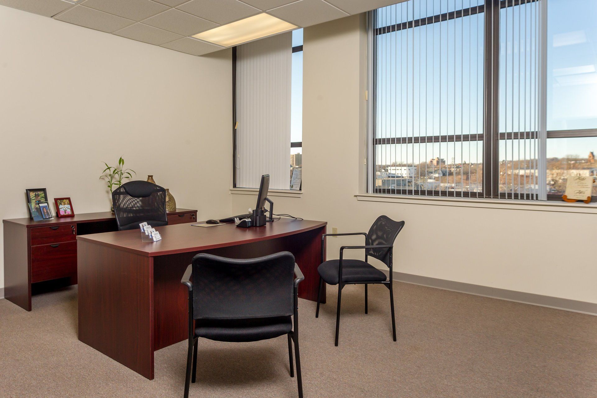 A small office with a desk and two chairs