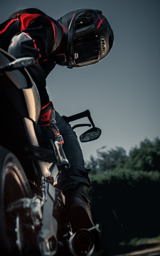 A man is riding a motorcycle down a road.