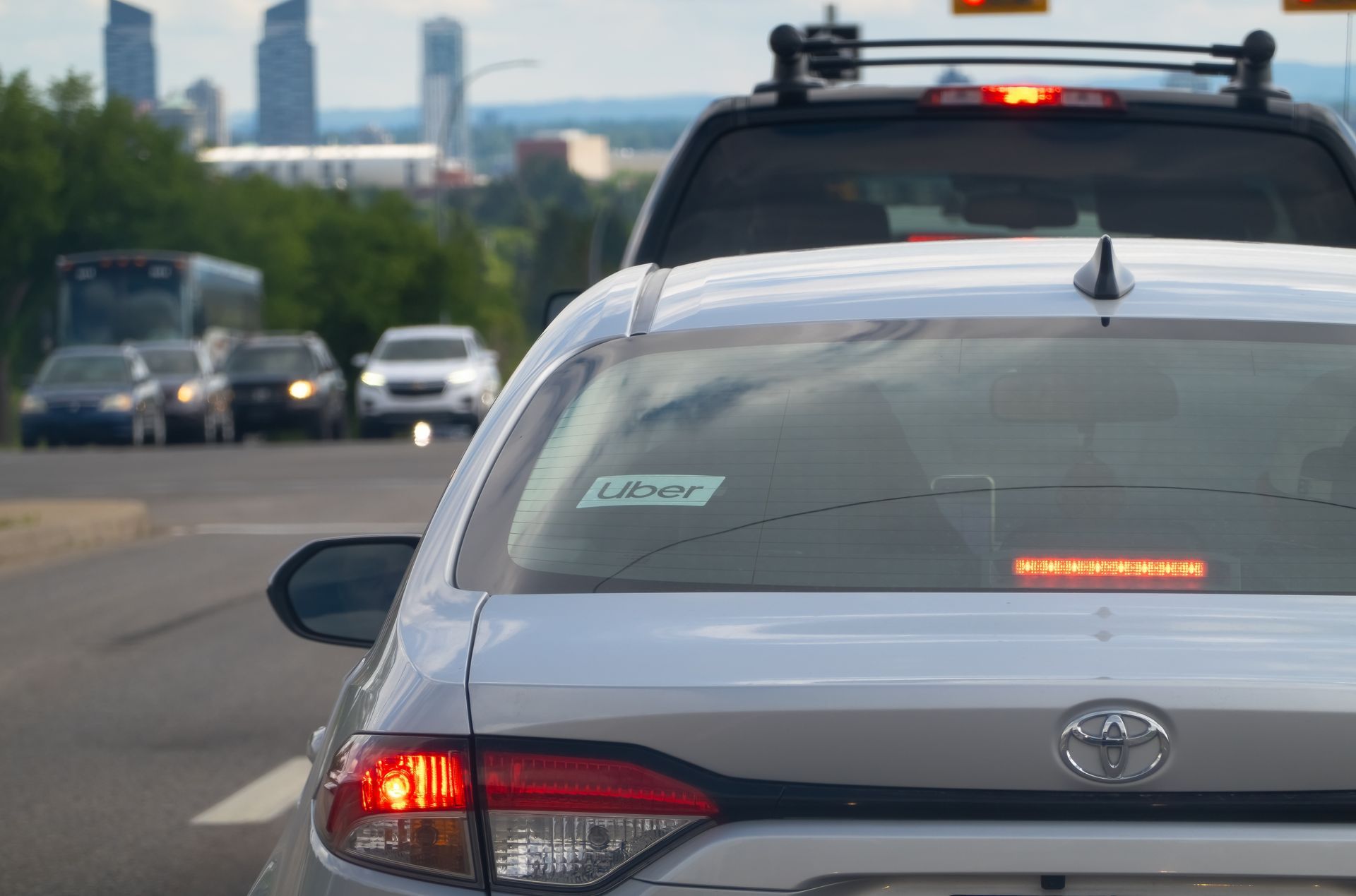 White Toyota car in traffic with a