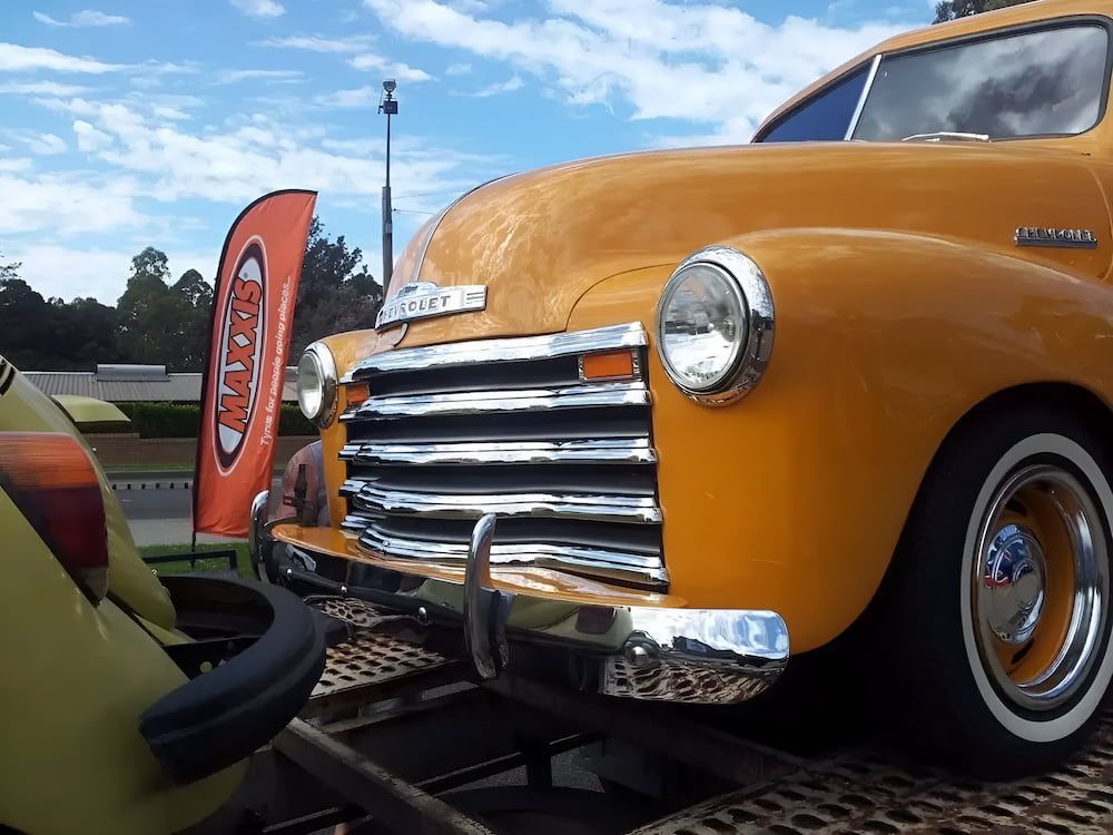 A Yellow Chevrolet Truck Is Parked On A Trailer — Figtree Brake & Clutch Services in Figtree, NSW