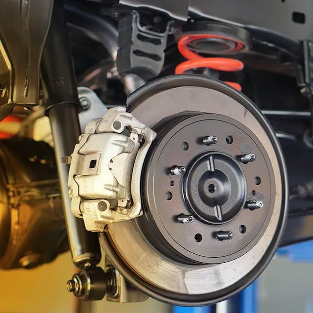 A Car's Brake System On A Lift — Figtree Brake & Clutch Services in Figtree, NSW