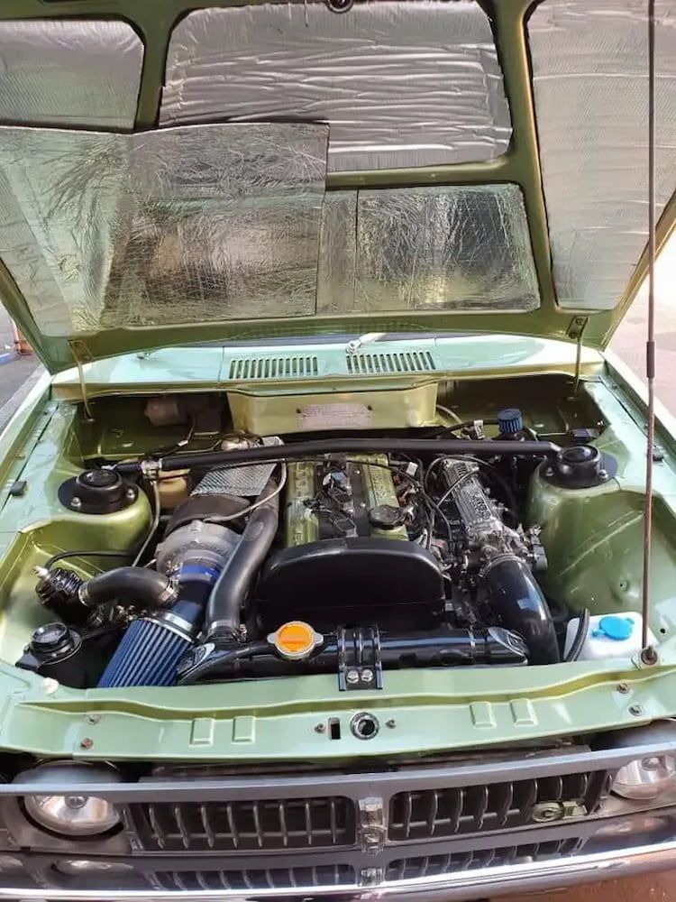 The Hood Of A Green Car Is Open And Shows The Engine — Figtree Brake & Clutch Services in Unanderra, NSW