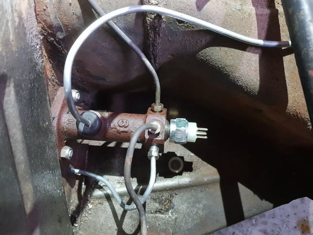 A Brake Cylinder With A Hose Attached To It — Figtree Brake & Clutch Services in Coniston, NSW