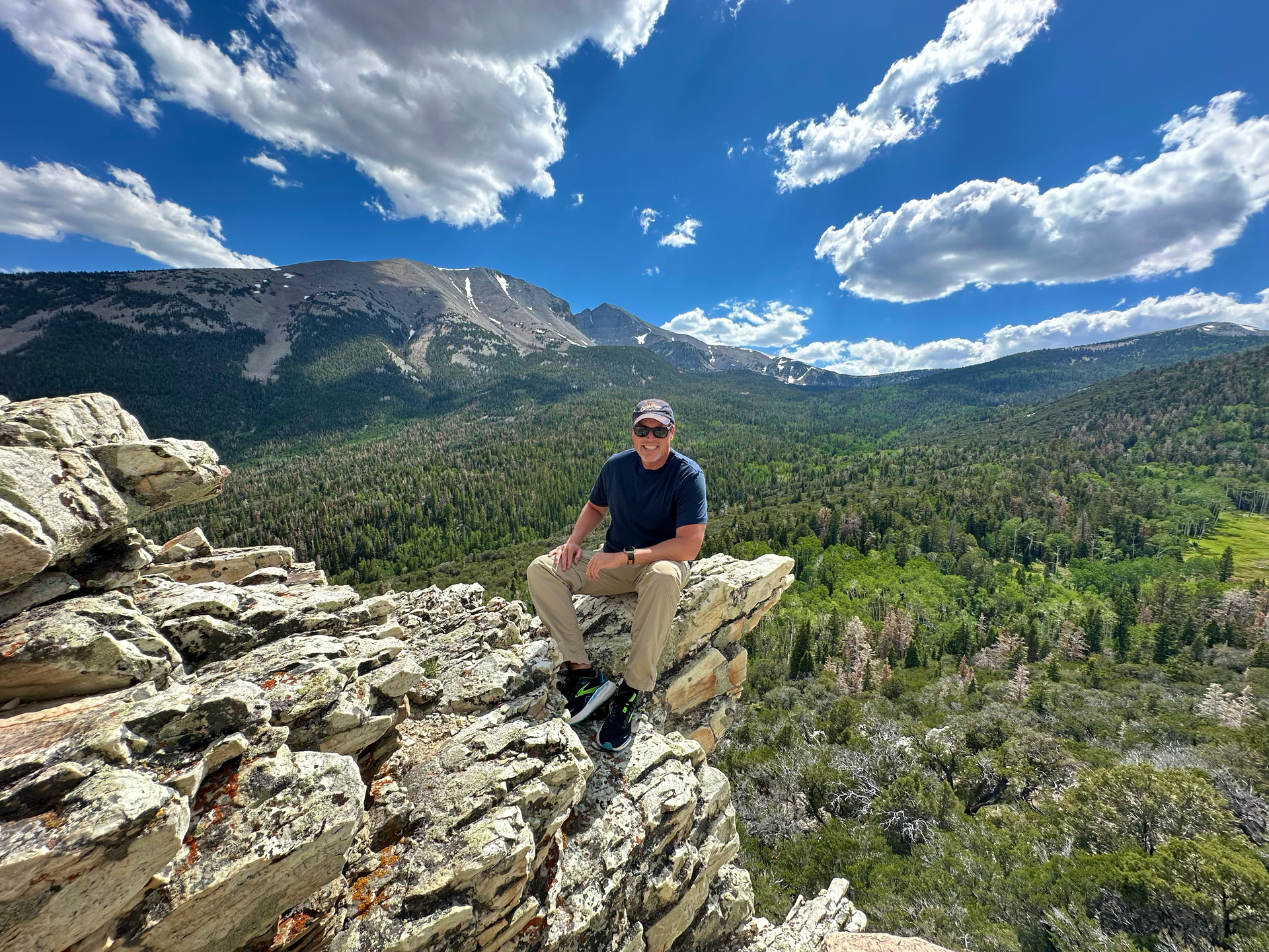 John is sitting on a rock on top of Wheeler Mountain in Great Basin National Park.