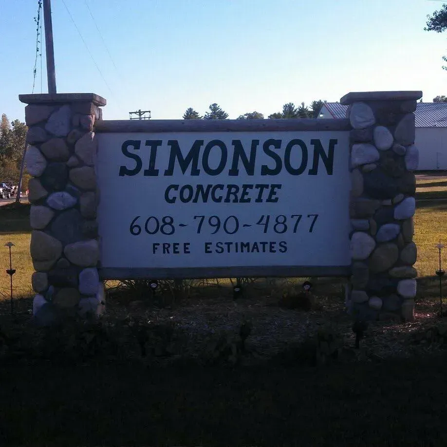 A red construction crane stands above the glass-paneled facade of a building under construction.