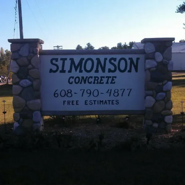 A red construction crane stands above the glass-paneled facade of a building under construction.
