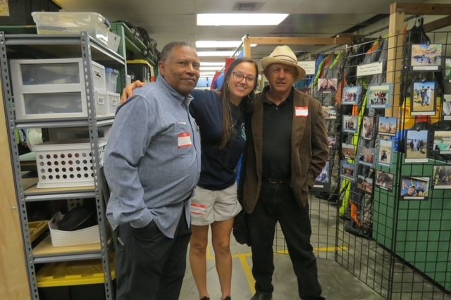 Three people are posing for a picture in a store