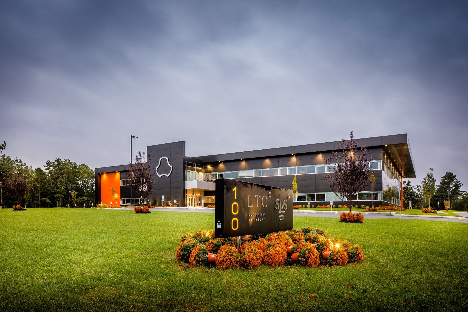 A large building with a sign in front of it.