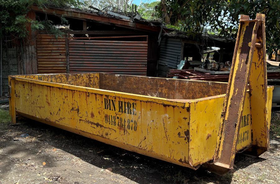 A Large Yellow Dumpster is Parked in Front of a Building — Bin Hire in Maryborough, QLD
