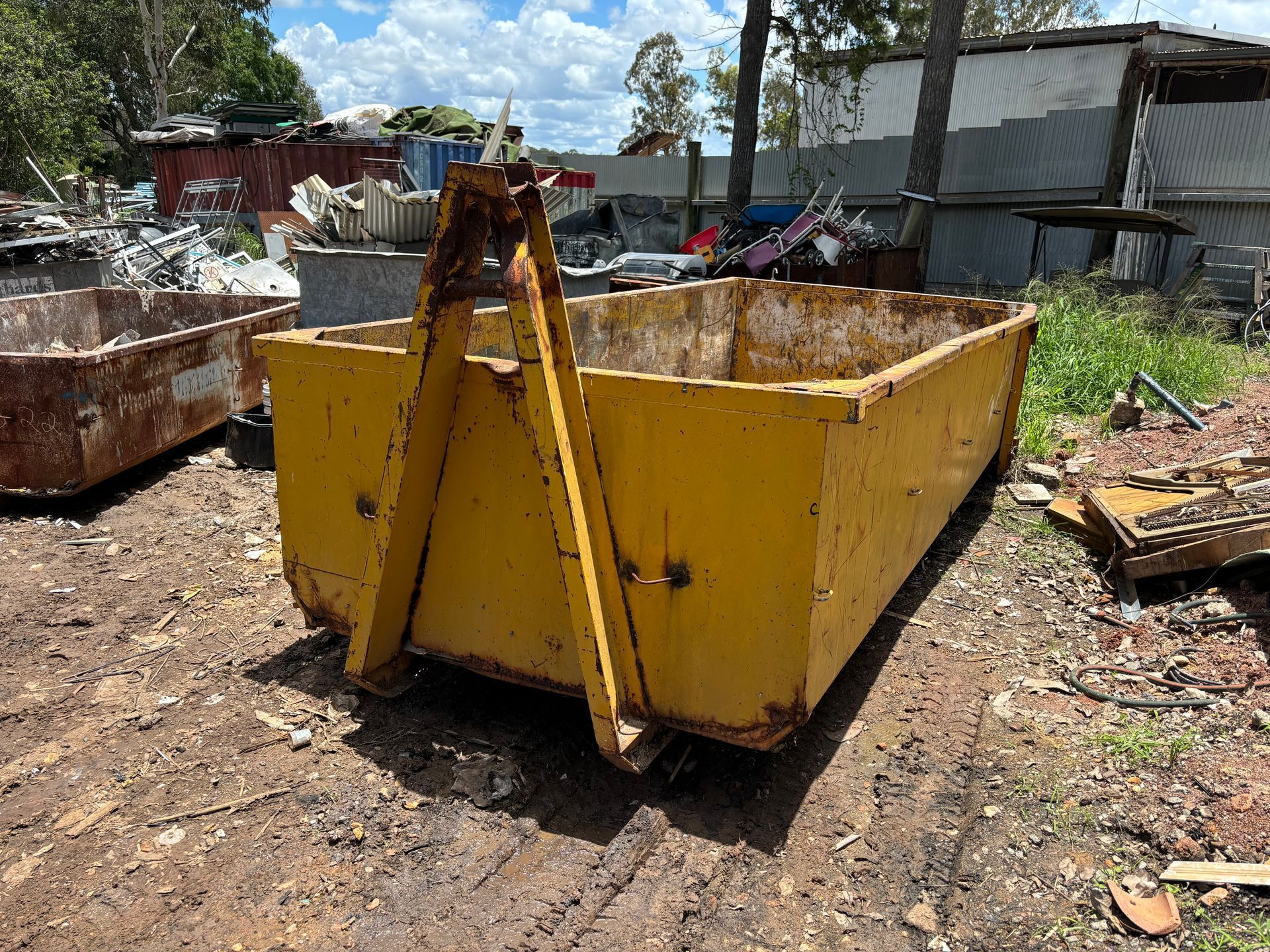 A Yellow Skip Bin In A Field — Bin Hire in Maryborough, QLD