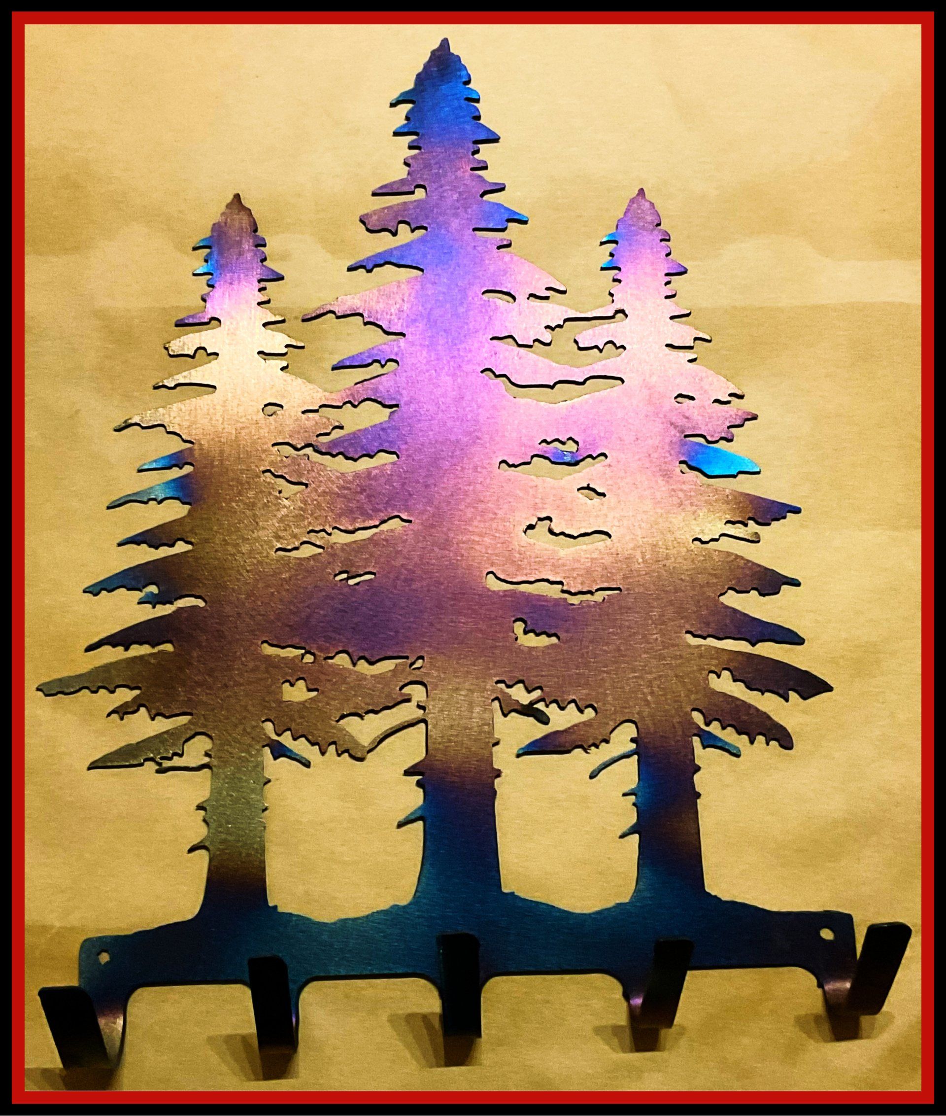 a metal sculpture of three trees with a purple sky in the background