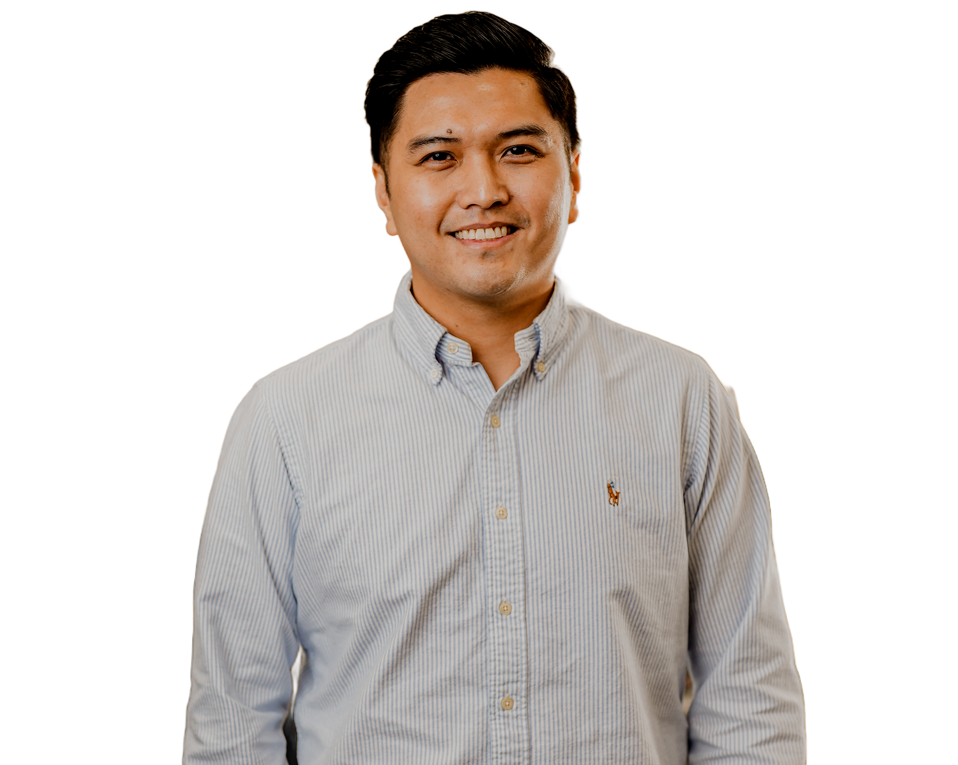 Smiling man in a light blue button-down shirt. White background.