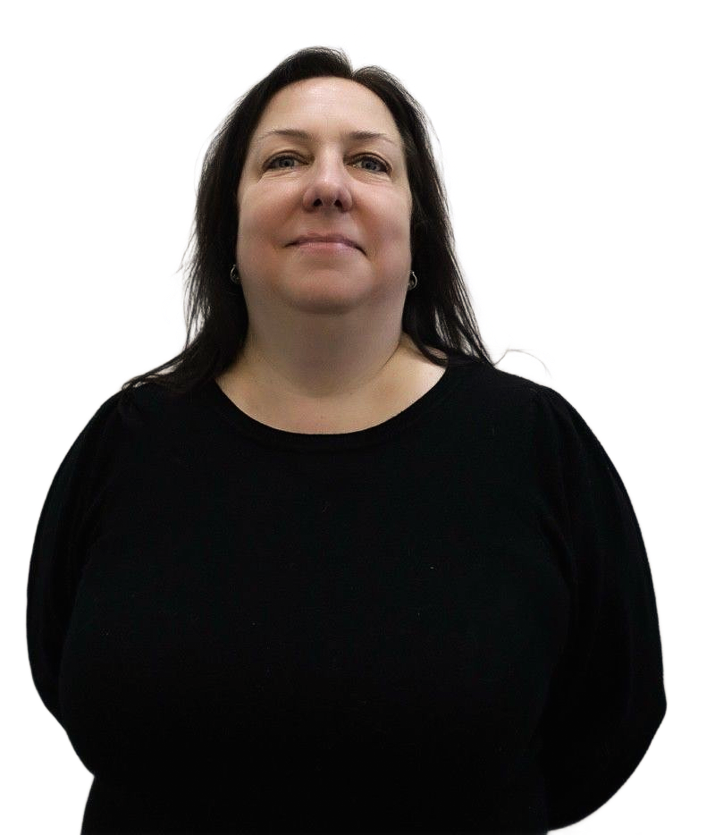 Woman in black sweater, looking upwards with a slight smile, against a white wall.
