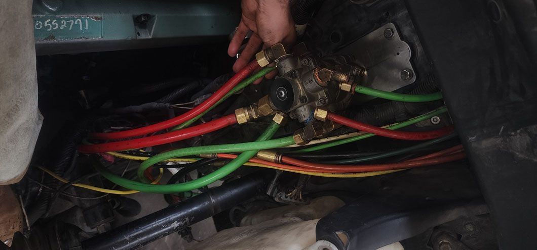 A person is working on the electrical system of a car.