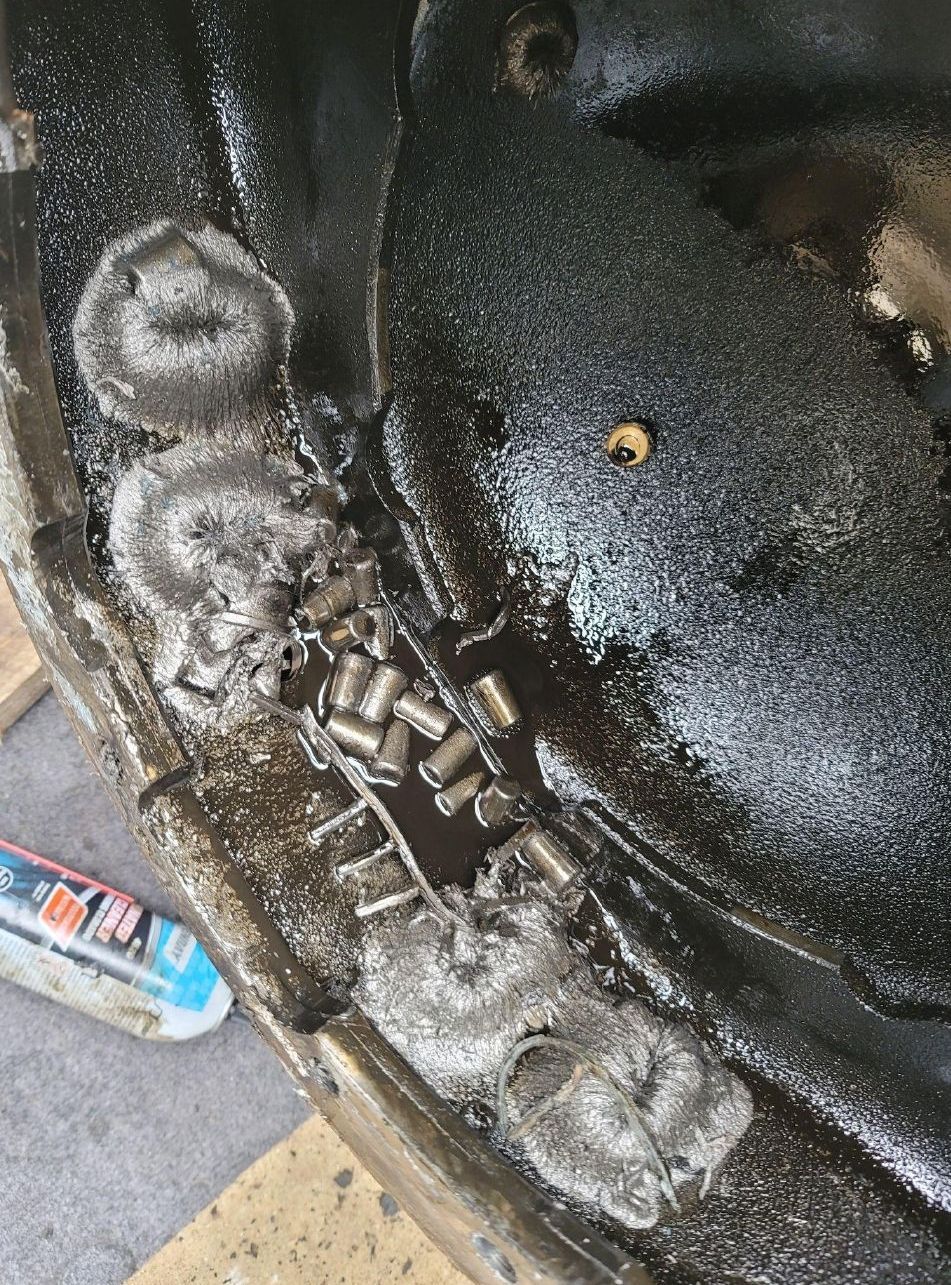 A close up of a piece of metal with a screw in it