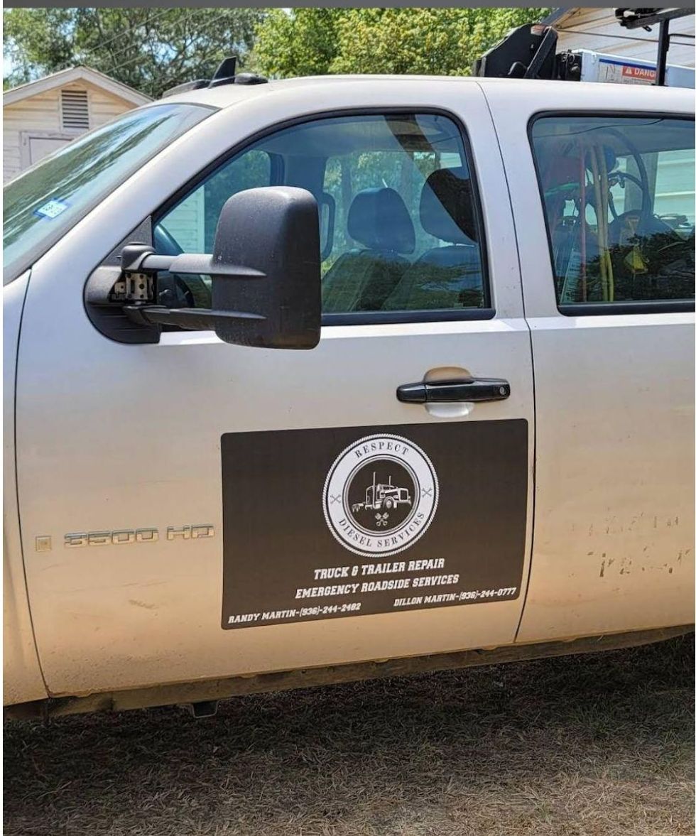 A silver truck with a black sticker on the side