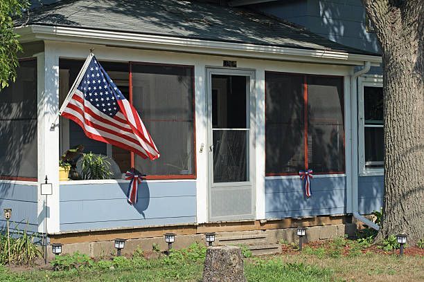 An american flag is flying on the porch of a house