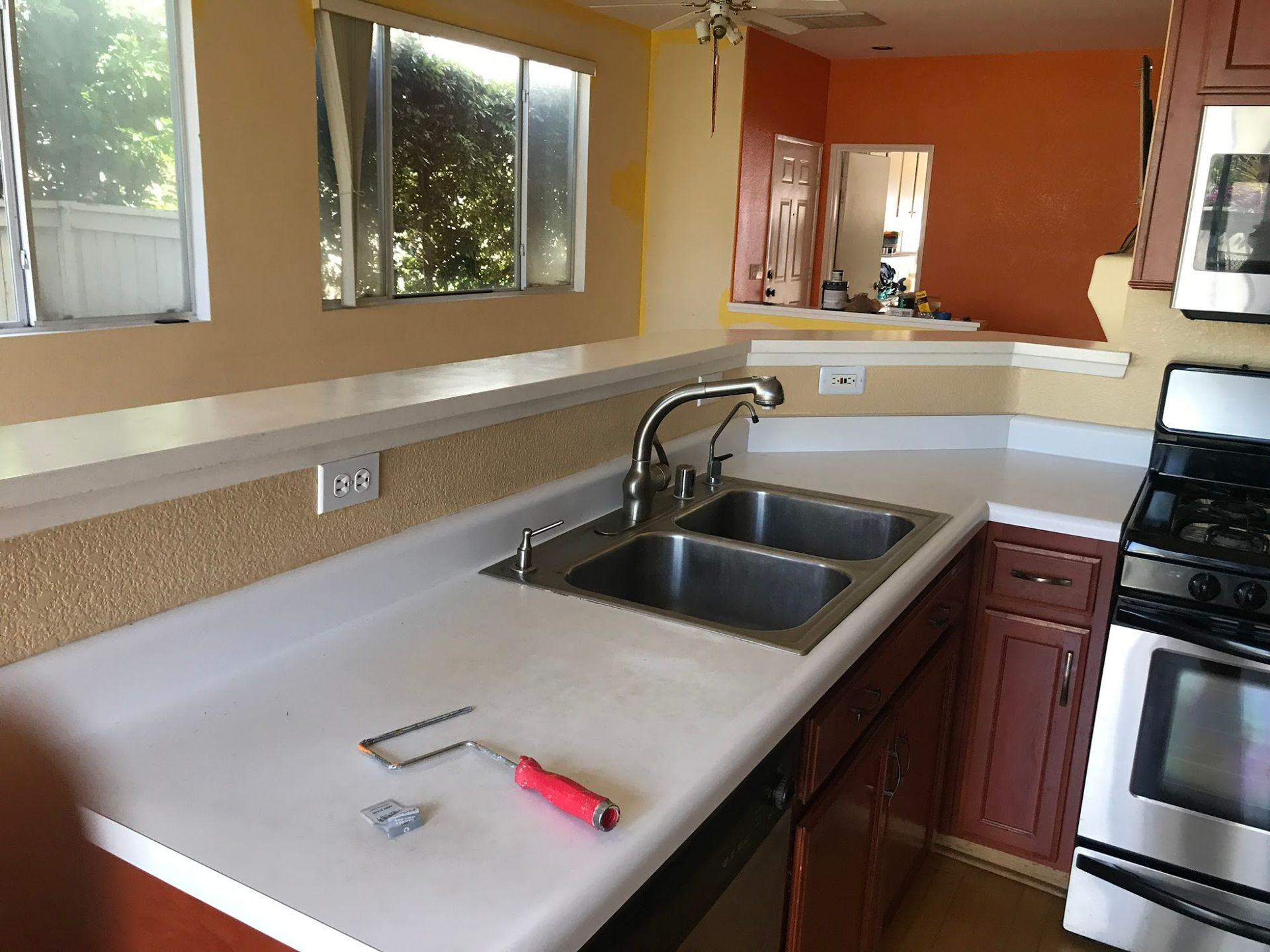 A kitchen with two sinks and a stove