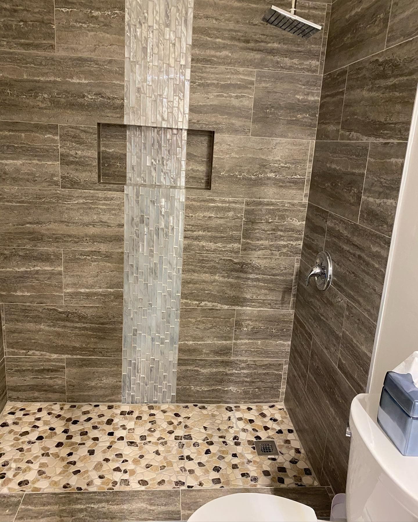 A bathroom with a walk in shower and a toilet.