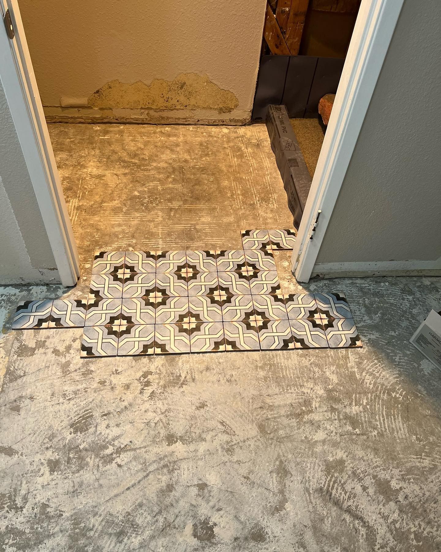 A doorway leading to a bathroom with a tiled floor.