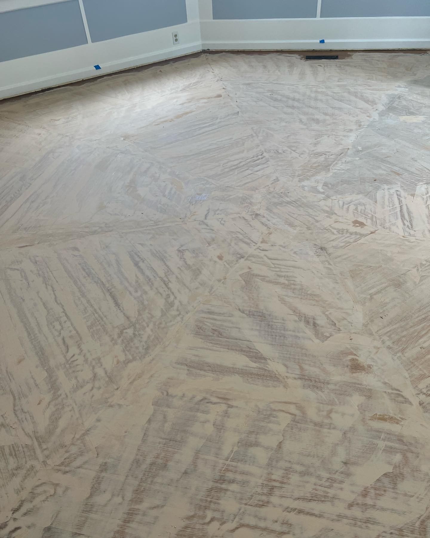 A wooden floor with a lot of sand on it