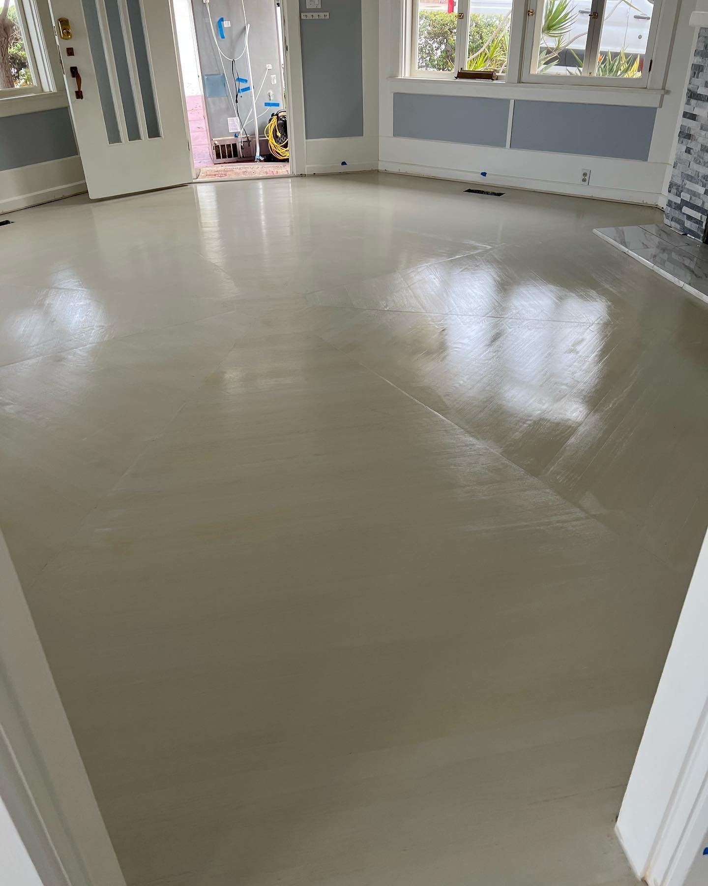 A living room with a white floor and a fireplace.