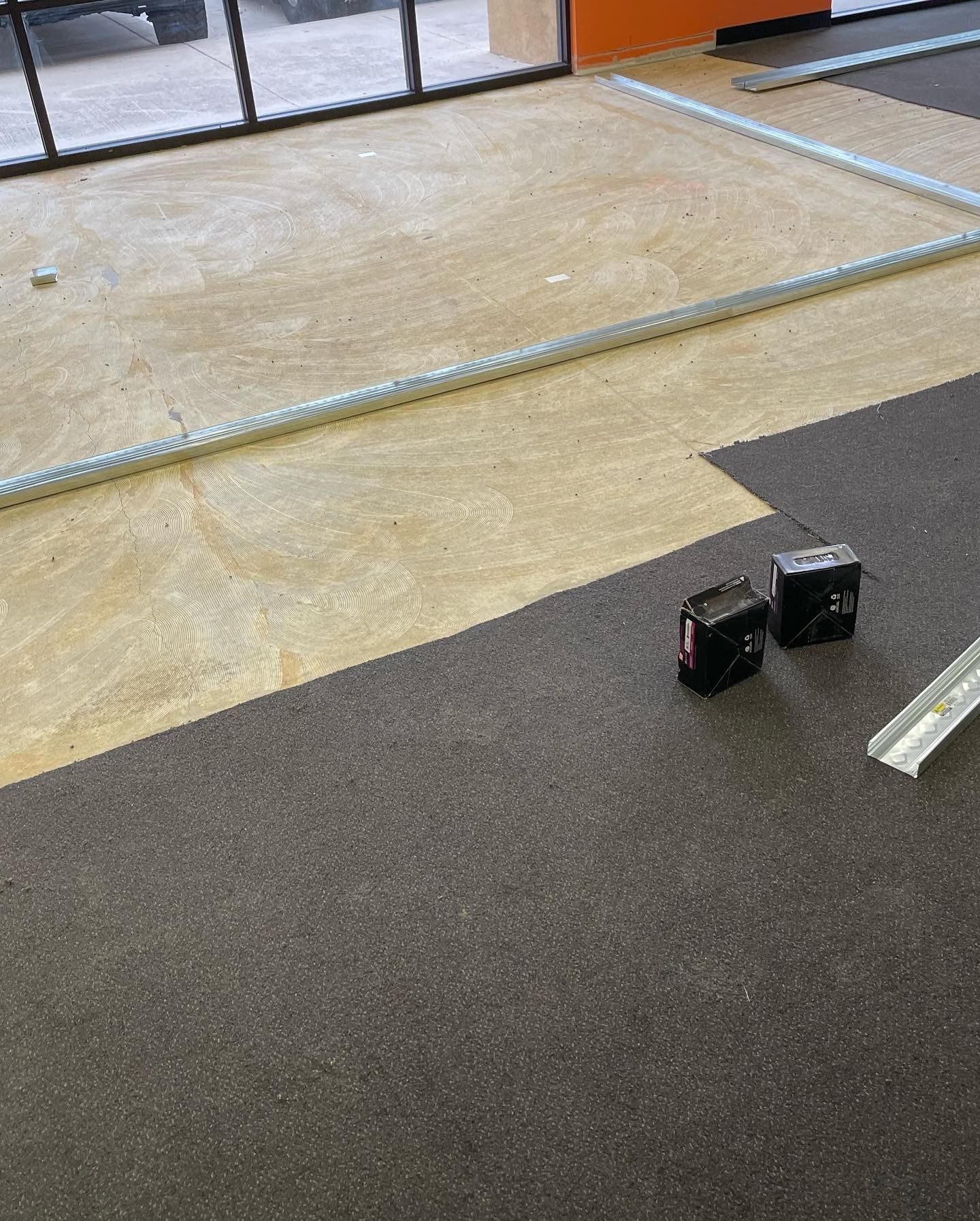 A carpeted floor with a measuring tape on it